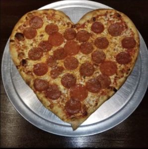 image of pizza shaped into a heart on a silver serving plate atginos Restaurant Portsmouth
