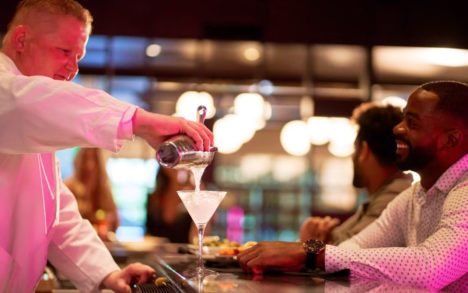 Image of a bartender pouring a drink to a patron at the Sound Bar inside of Rivers Casino Portsmouth