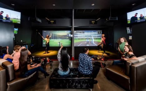 Image of a group of people playing virtual games at TopGolf at Rivers Casino Portsmouth, VA